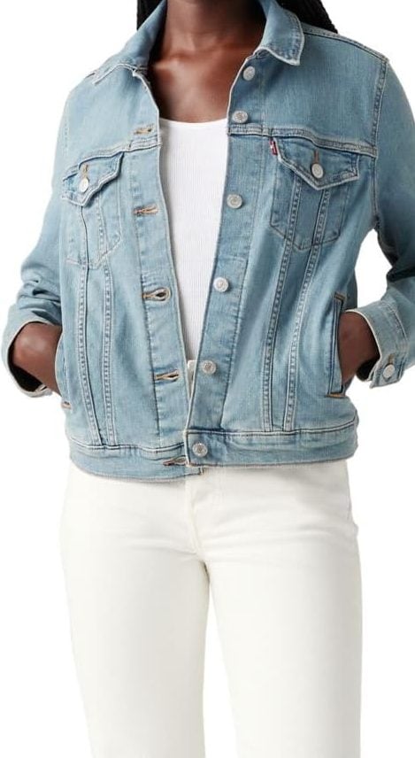 A person wearing a light blue denim jacket over a white ribbed top and white pants, hands in the jacket pockets&mdash;perfect for refreshing your wardrobe during the Amazon Big Spring Sale.