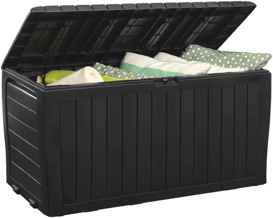 A black outdoor storage box with an open lid, containing folded green and white patterned cushions and blankets&mdash;perfect for organizing your patio during the Amazon Big Spring Sale.