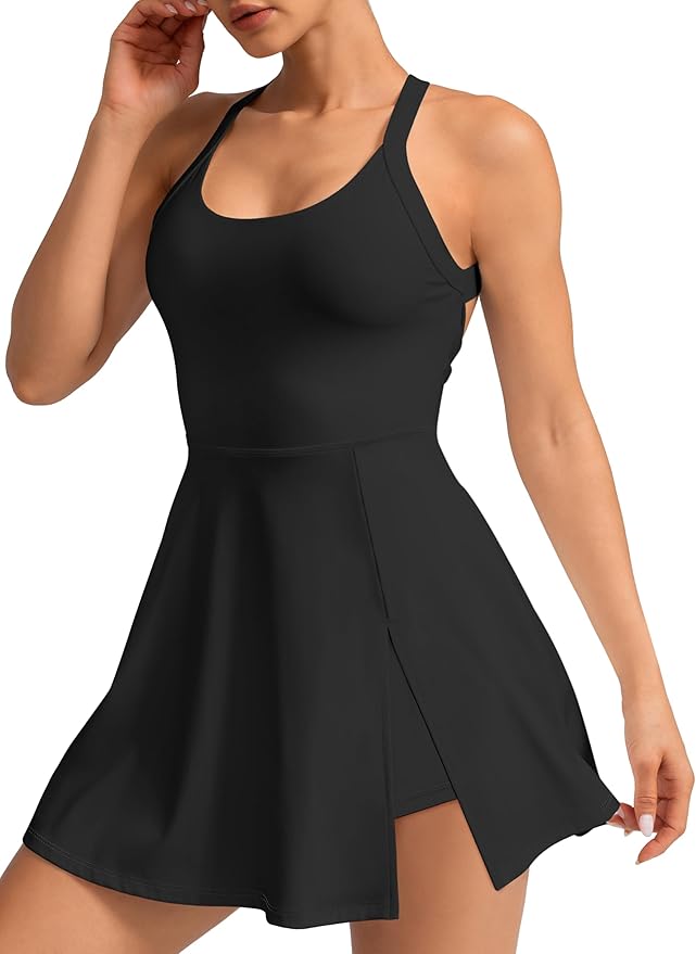 Woman wearing a sleeveless black athletic dress with a fitted top, flared skirt, and racerback straps, lifting the skirt slightly to reveal built-in shorts&mdash;perfect for snagging at the Amazon Big Spring Sale.