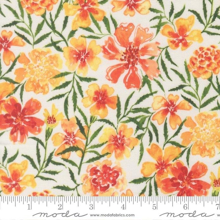 Floral fabric with orange and yellow marigold-like flowers and green leaves on a white background, shown with a measuring ruler at the bottom.