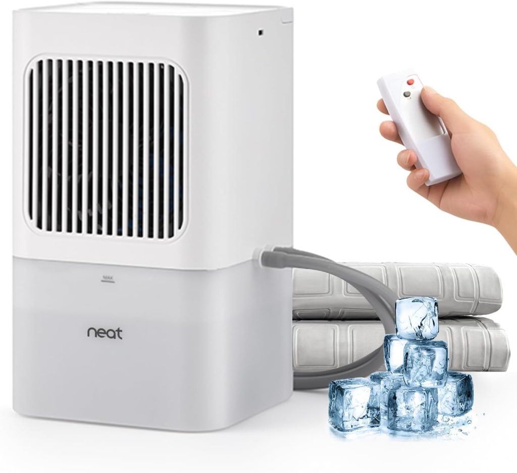 A white portable air cooler from Inspired Home with a remote control, an attached hose, two cooling packs, and ice cubes in front.