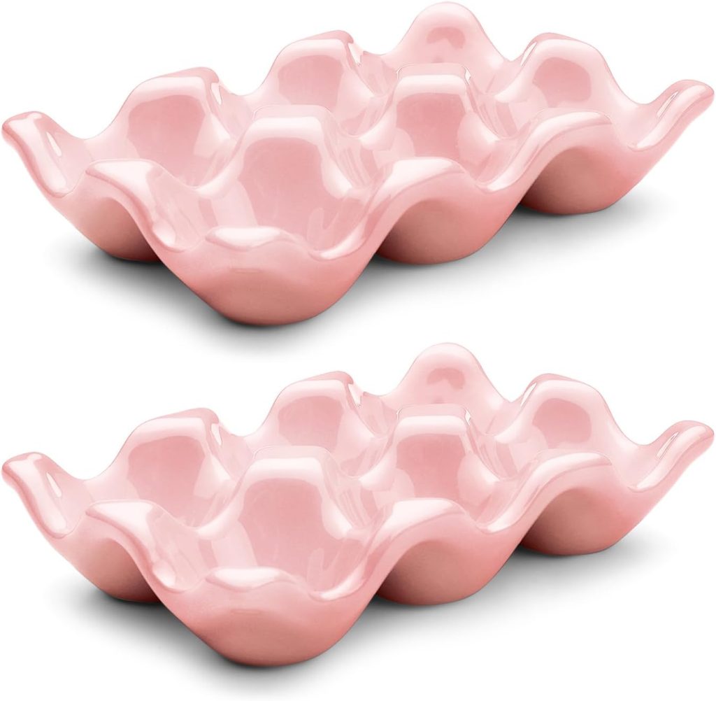 Two pink ceramic egg trays, each with six compartments and wavy edges, displayed on a white background.