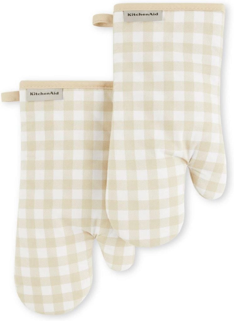 Two beige and white checkered oven mitts with "KitchenAid" labels are laid flat on a white background, perfect for upgrading your kitchen during the Amazon Big Spring Sale.