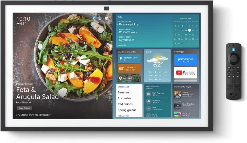 A smart display screen shows a salad recipe, weather, calendar events, and smart home controls, with a remote control placed beside it&mdash;making every day easier just in time for the Amazon Big Spring Sale.