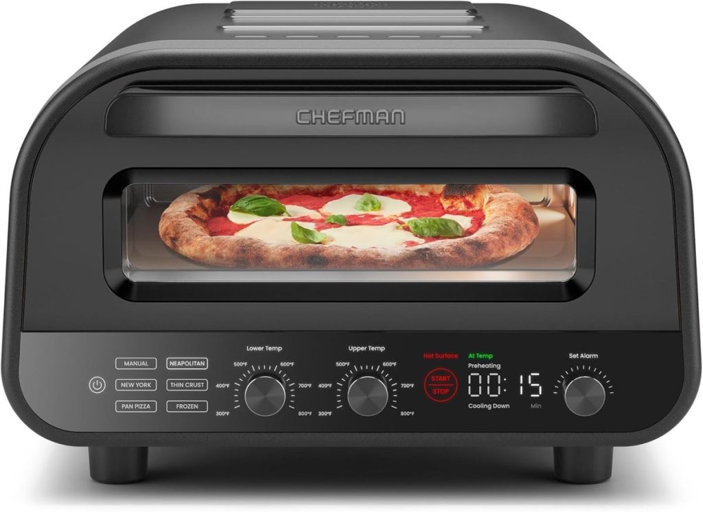 A countertop Chefman pizza oven with a digital display shows a pizza baking inside, topped with cheese, tomato sauce, and basil leaves&mdash;perfect for grabbing during the Amazon Big Spring Sale.