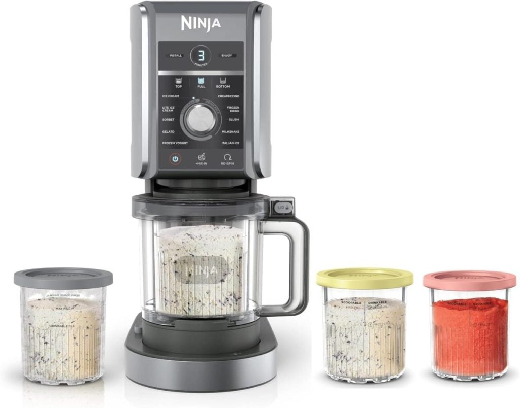 A Ninja food processor unit with a mixing bowl attached and three storage containers, each with a colored lid&mdash;perfect for meal prep or organizing ingredients during the Amazon Big Spring Sale.