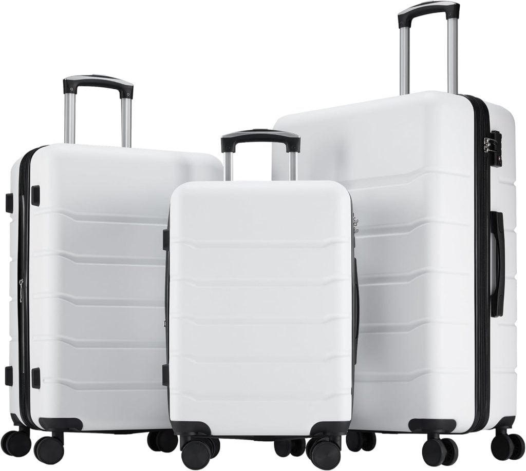 Three white hard-shell suitcases of different sizes with black handles and wheels are displayed side by side, perfect for your next getaway. Shop now and save during the Amazon Big Spring Sale.