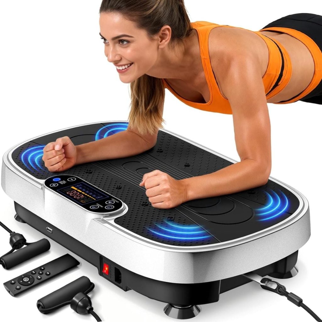 A woman in athletic wear holds a plank on a vibrating exercise platform, which displays blue lights; remotes and resistance bands on the floor suggest she's ready for the Amazon Big Spring Sale workout upgrades.