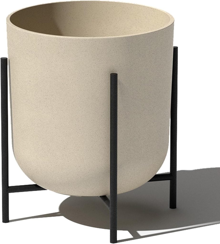 Beige cylindrical planter with a rounded bottom, placed on a black metal stand with four legs, casting a shadow to the right&mdash;an elegant piece perfect for refreshing your space during the Amazon Big Spring Sale.