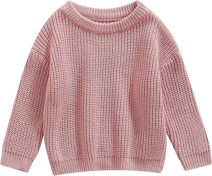 A pink knitted sweater with a round neckline, long sleeves, and ribbed cuffs and hem.