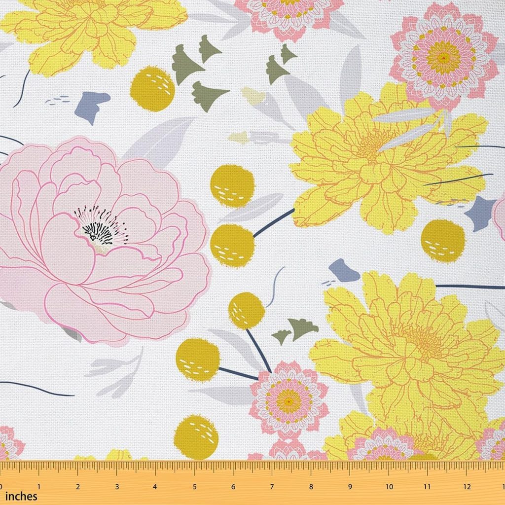 Fabric with a floral pattern featuring large yellow and pink flowers, green leaves, and a yellow measuring ruler along the bottom edge showing inches.