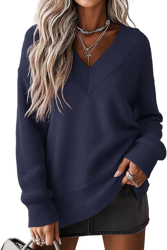 A person wearing a navy blue V-neck sweater, layered necklaces, rings, and a dark mini skirt, with wavy light blonde hair—ready for a stylish day in my life.