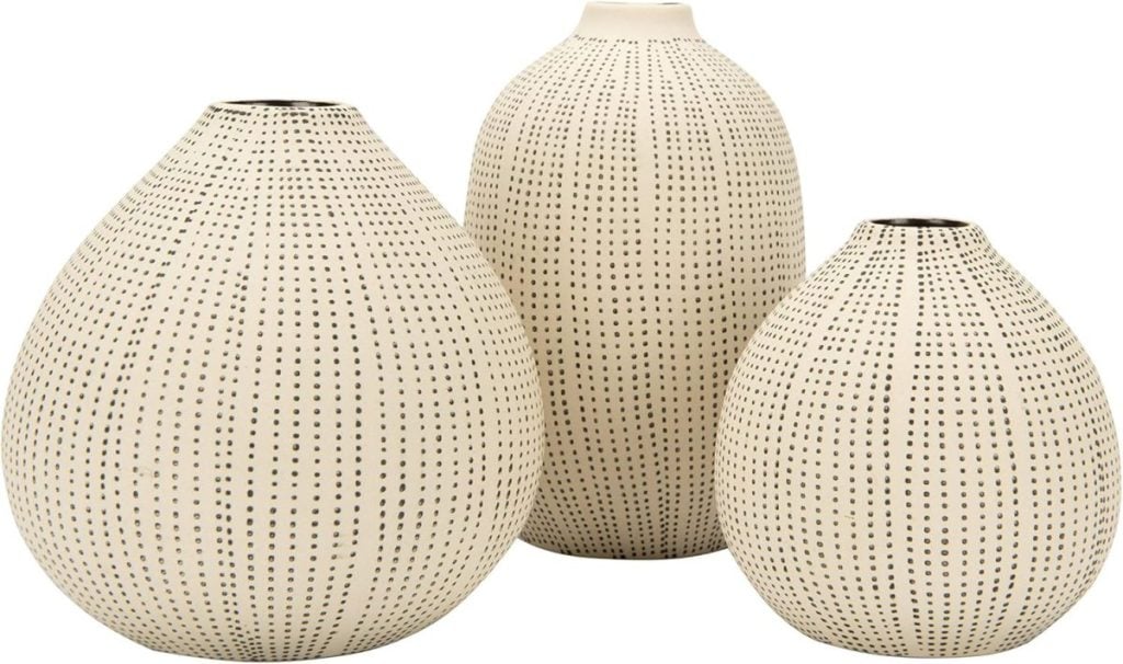 Three cream-colored ceramic vases with rounded shapes and a pattern of small, evenly spaced black dots are arranged side by side against a white background&mdash;an elegant decor idea inspired by the Amazon Big Spring Sale.