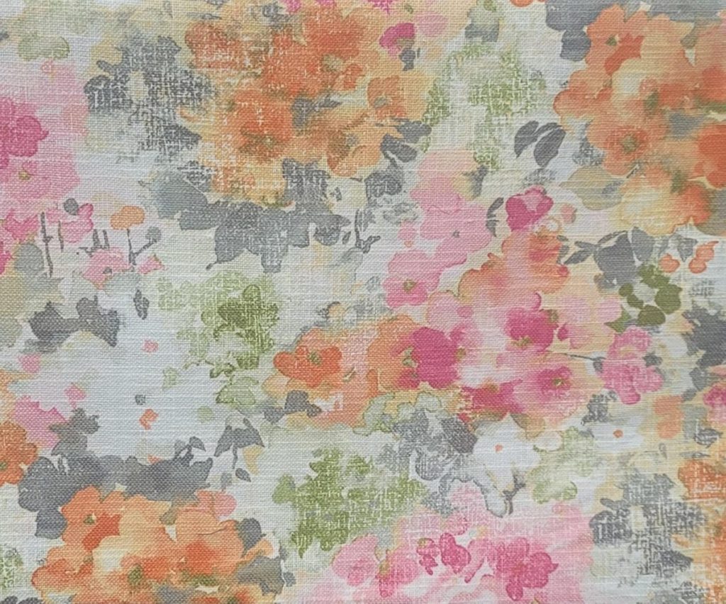 Abstract floral pattern with orange, pink, green, and gray watercolor-like blotches on a textured white background.