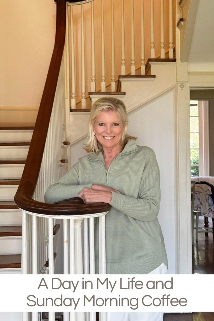 A woman in a light green sweater stands smiling by a wooden staircase in a home. Text reads: "A Day in My Life and Sunday Morning Coffee.