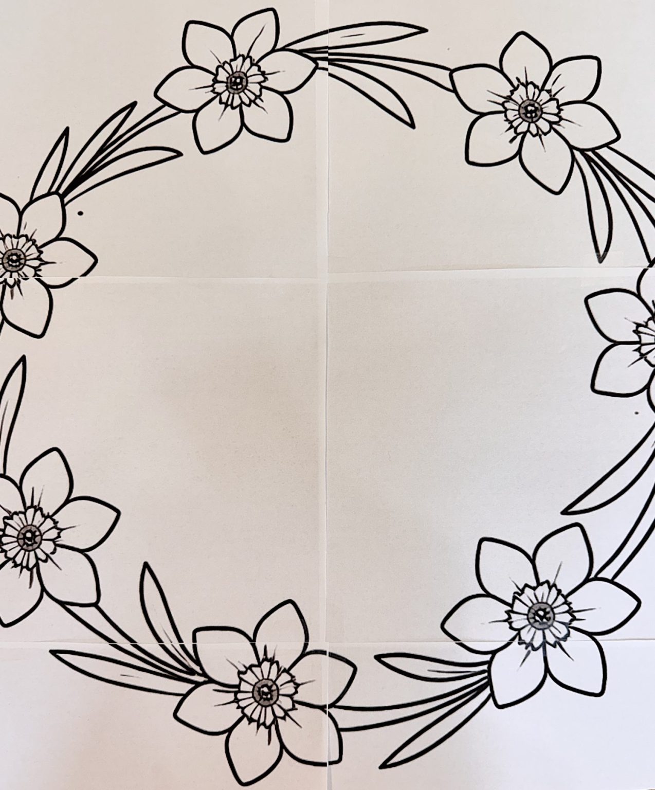A black and white floral wreath outline features six flowers with leaves arranged in a circular pattern on a plain background.
