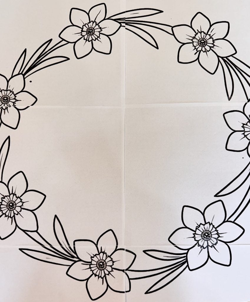 A black and white floral wreath outline features six flowers with leaves arranged in a circular pattern on a plain background.