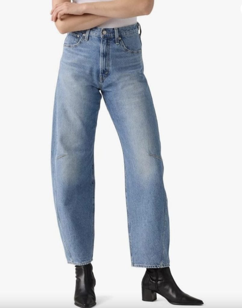 A person wearing high-waisted, light blue straight-leg jeans and black heeled ankle boots, standing against a plain white background&mdash;perfect inspiration for your next Amazon Big Spring Sale find.