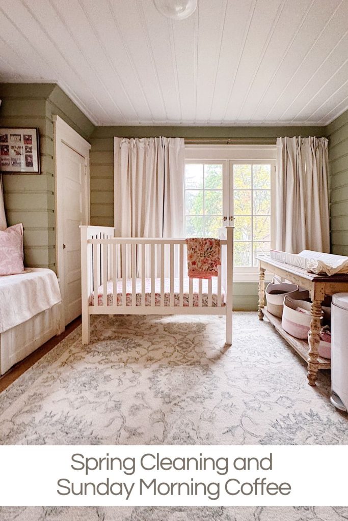 A tidy nursery with a white crib, a changing table, a cushioned bench, and large windows with cream curtains. Text reads: "Spring Cleaning and Sunday Morning Coffee.