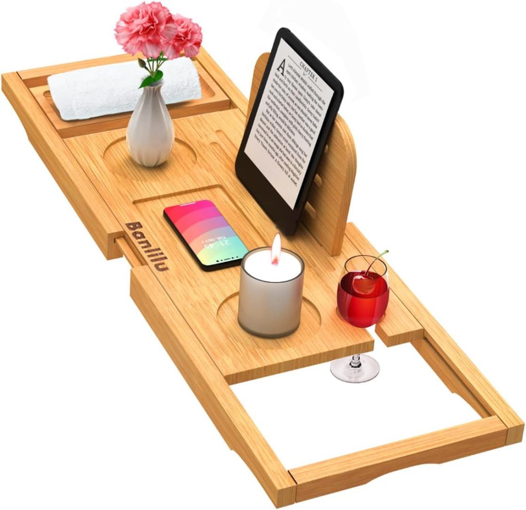 A bamboo bathtub tray holding a towel, flowers, e-reader, smartphone, candle, wine glass, and a red drink in a tumbler makes one of the perfect Mother&rsquo;s Day Gifts on Amazon.