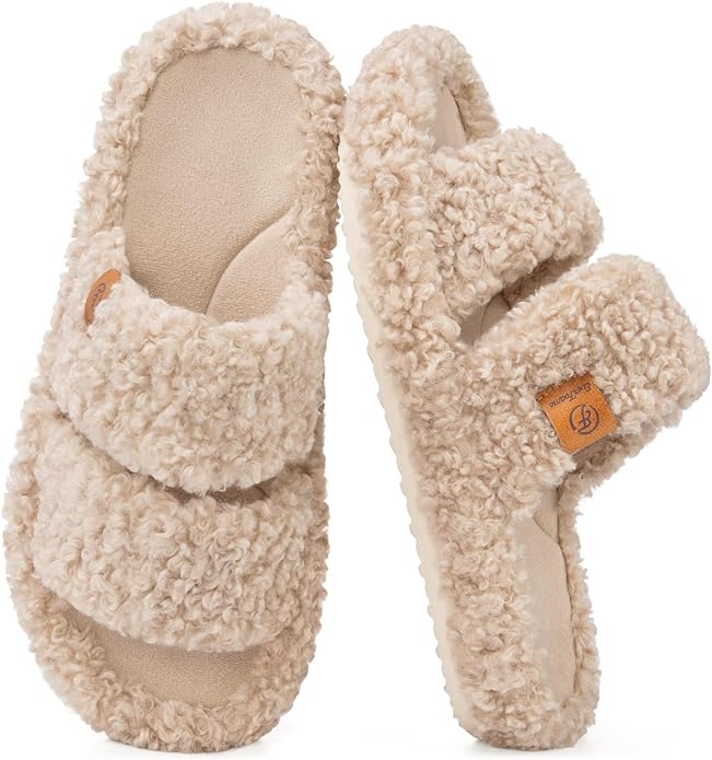 Pair of beige, fuzzy, open-toe slippers with two wide straps and textured soles, shown from a top and side angle&mdash;perfect as cozy Mother&rsquo;s Day gifts on Amazon.