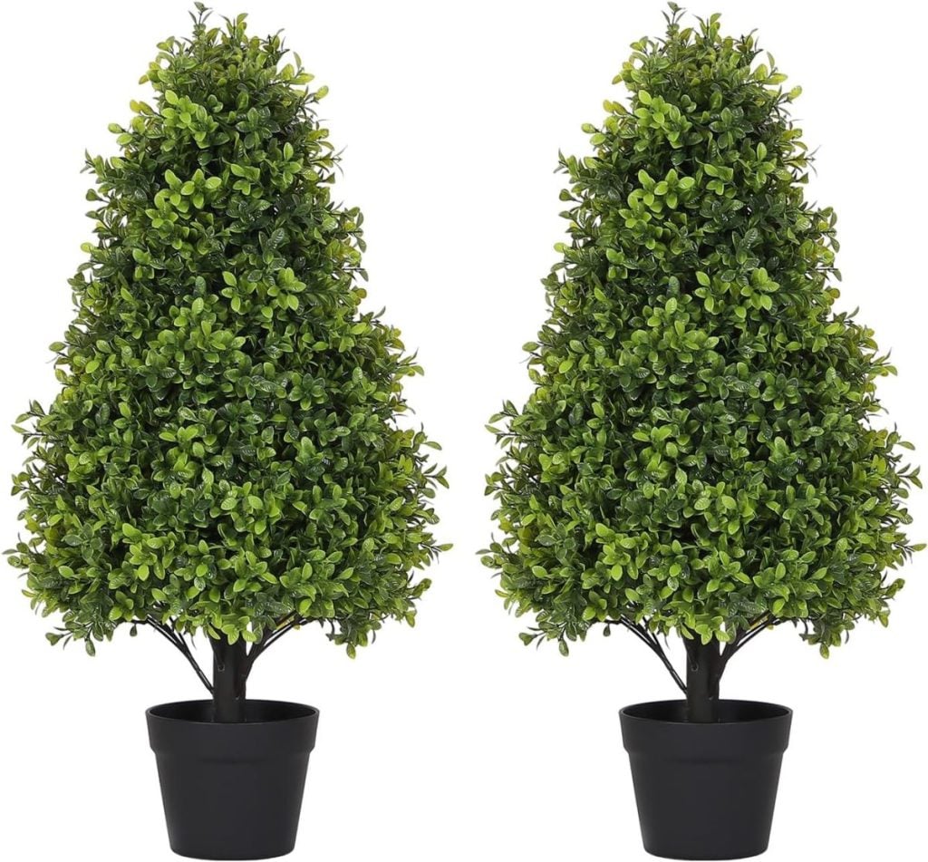 Two artificial topiary trees with dense green foliage in black pots, placed side by side against a white background.