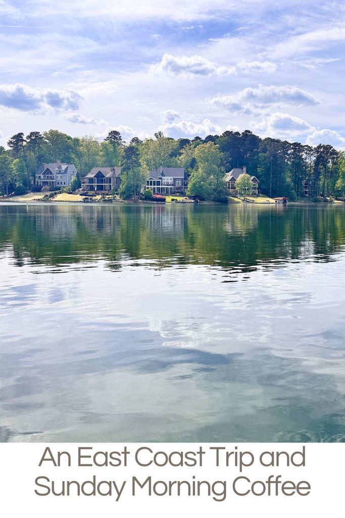 Lakeside houses reflected in calm water under a partly cloudy sky, with trees in the background and text reading "An East Coast Trip and Sunday Morning Coffee.
