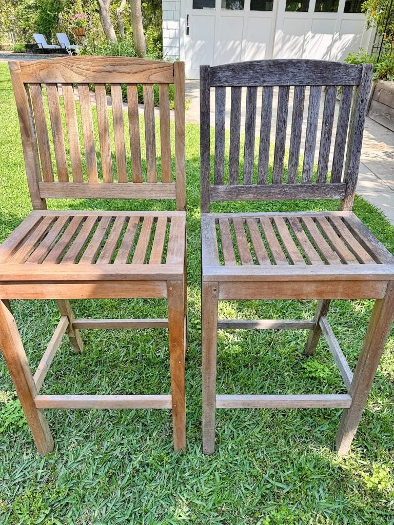 Two wooden chairs are side by side on grass; the chair on the left is light brown while the chair on the right is weathered and gray.