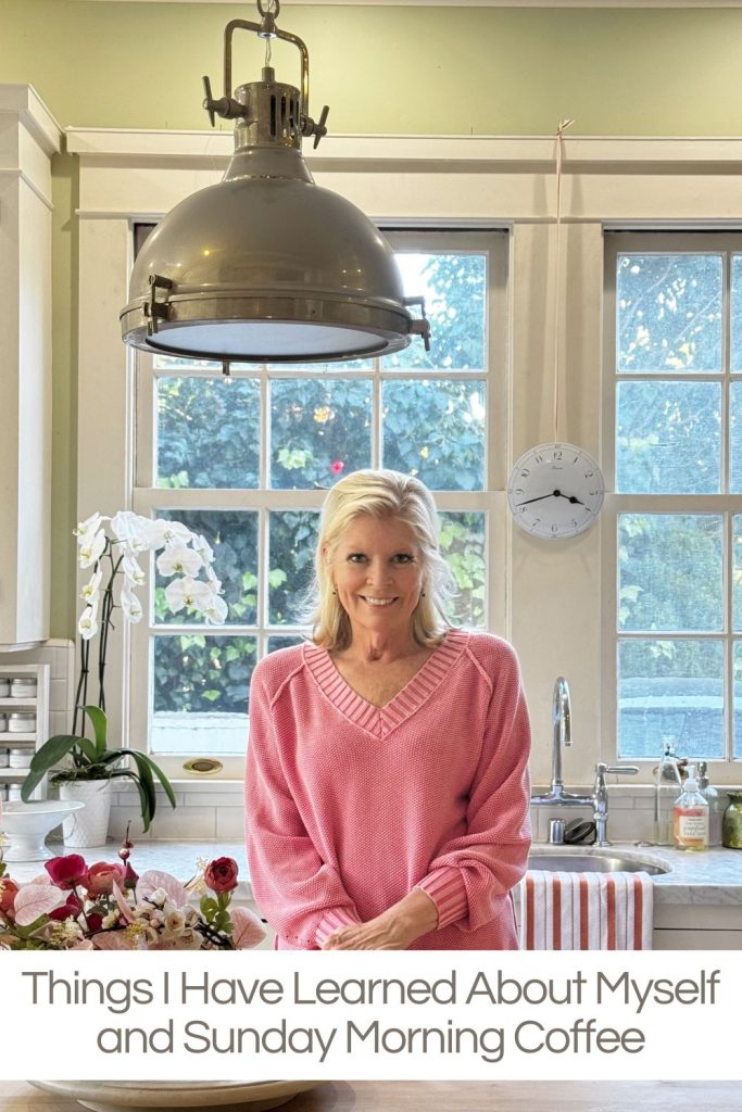 A woman in a pink sweater stands in a bright kitchen with flowers, an orchid, and a large hanging light fixture. Text reads: "Things I Have Learned About Myself and Sunday Morning Coffee.