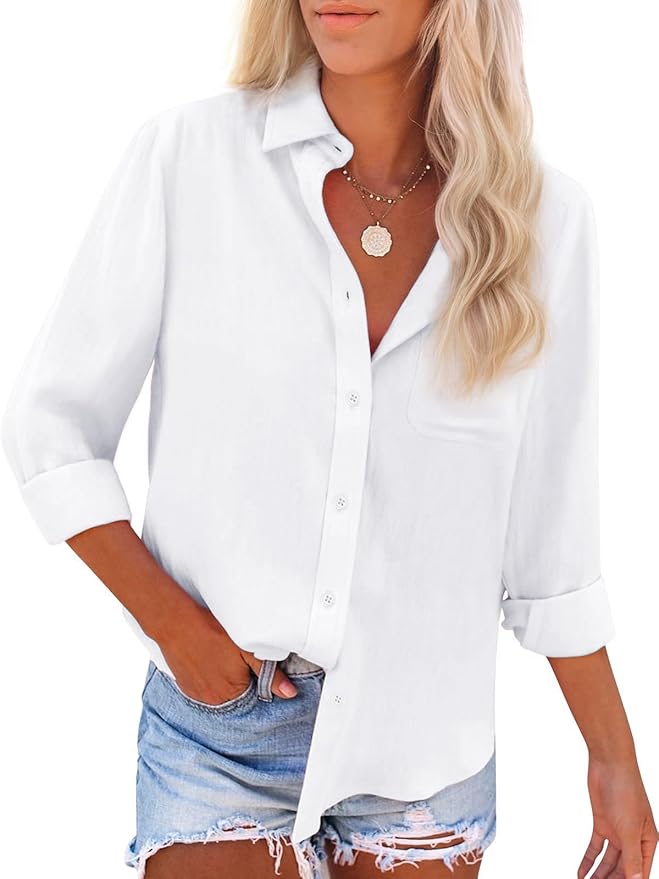 A woman wearing a white button-down shirt with rolled sleeves and light denim shorts, accessorized with layered necklaces.