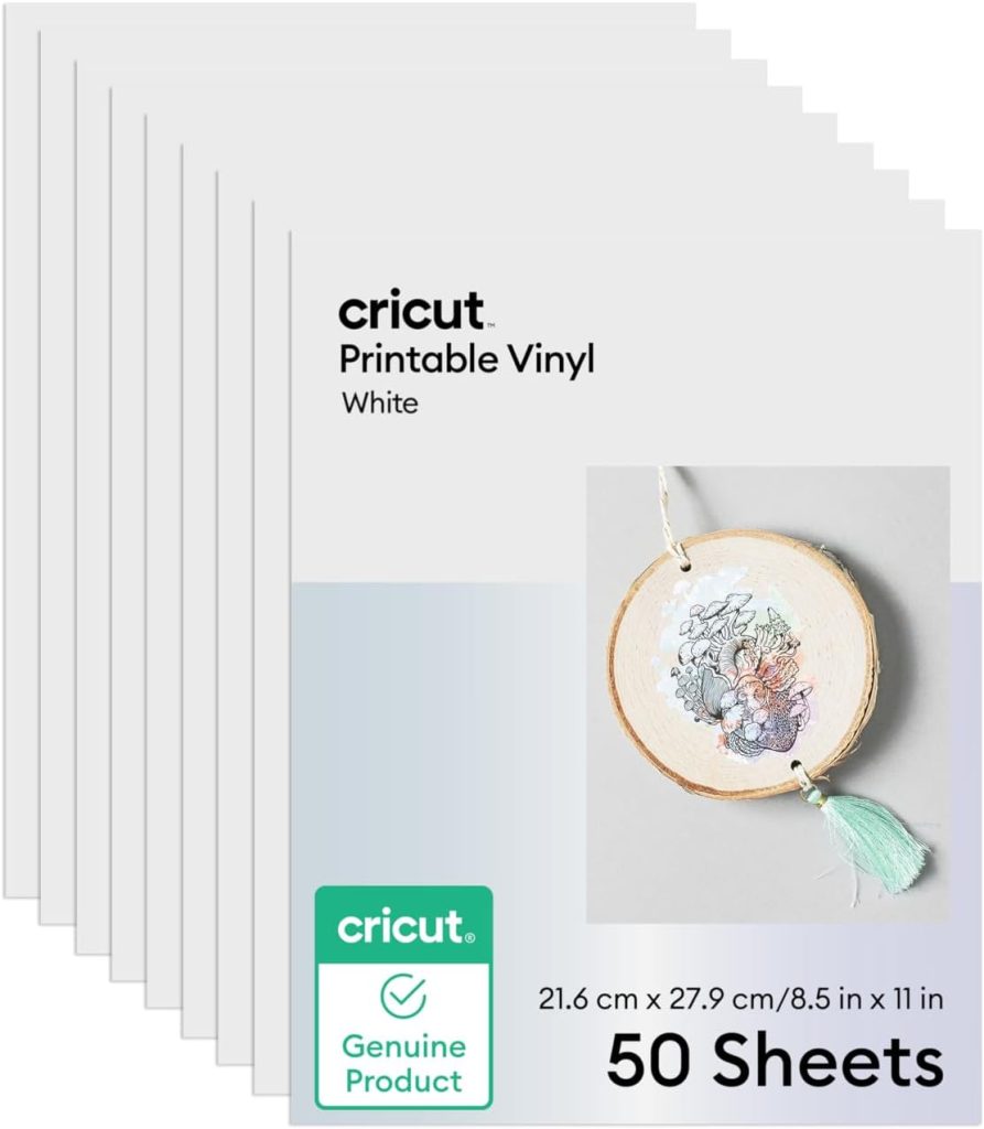 Stack of Cricut Printable Vinyl White sheets, 21.6 cm x 27.9 cm (8.5 in x 11 in), 50 sheets per pack, with an example craft and a "Genuine Product" label.