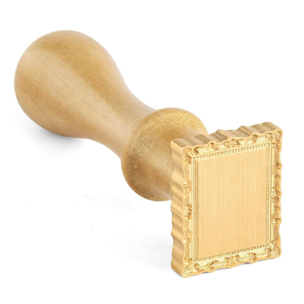 A wooden handle stamp with a square, ornate frame design on the stamping surface, perfect for creating elegant wax seals, placed on a white background.