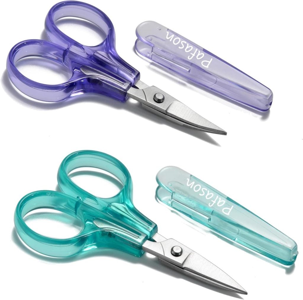 Two pairs of small scissors, one purple and one teal, each with matching protective covers labeled "PARSON," are shown on a white background.