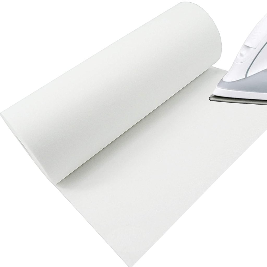 A white ironing mat is partially unrolled with the tip of an iron visible on the right side.