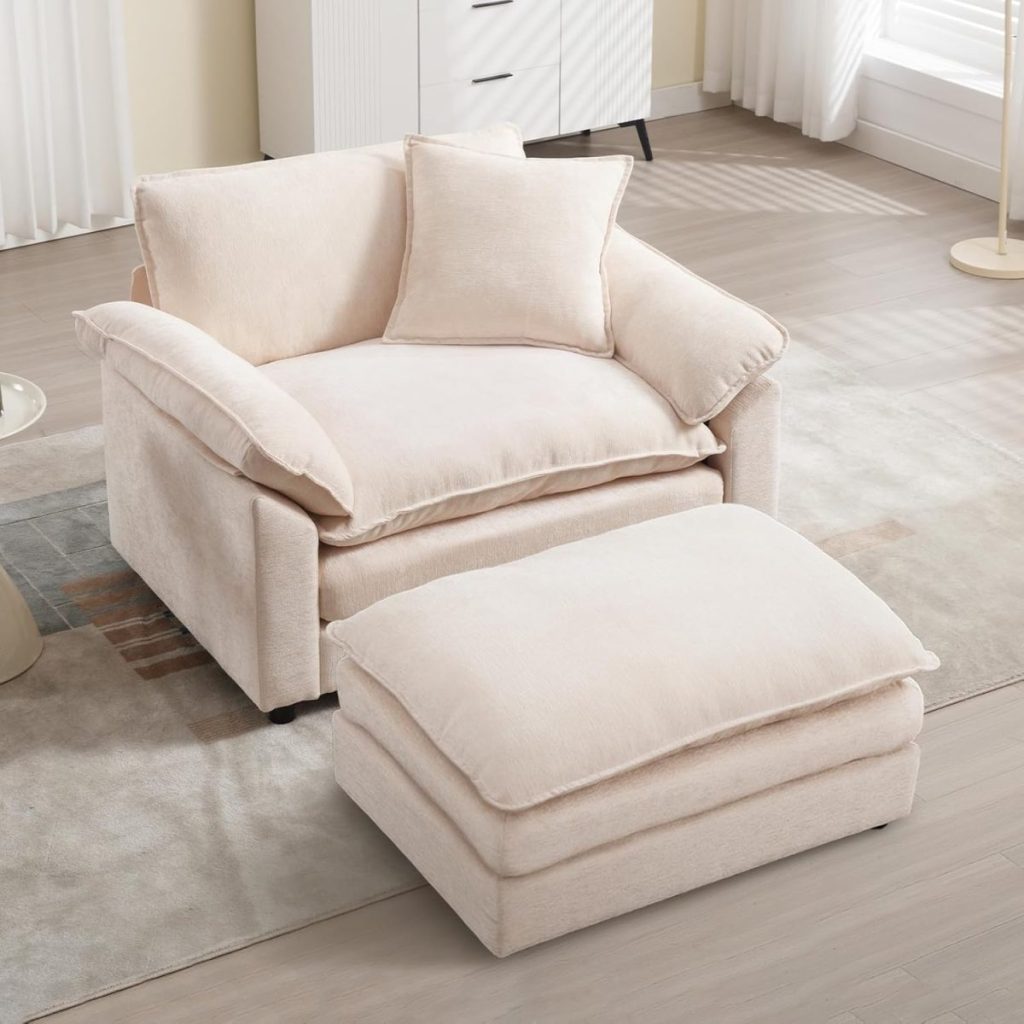 A large beige armchair with plush cushions and a matching ottoman sits on a light-colored rug in a sunlit room with wood flooring, creating an inviting space to relax—perfect as summer is coming.