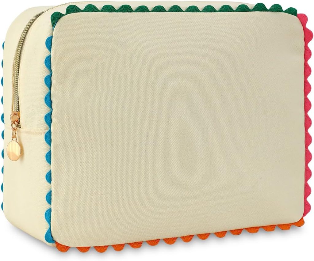 Square beige zippered pouch with a gold zipper and colorful scalloped trim along the edges in blue, green, orange, and pink.