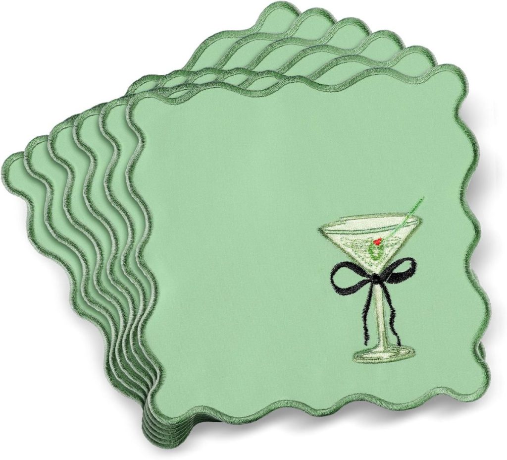 Stack of six light green embroidered cocktail napkins with scalloped edges, each featuring a martini glass stitched with a green olive and finished with a charming black bow.