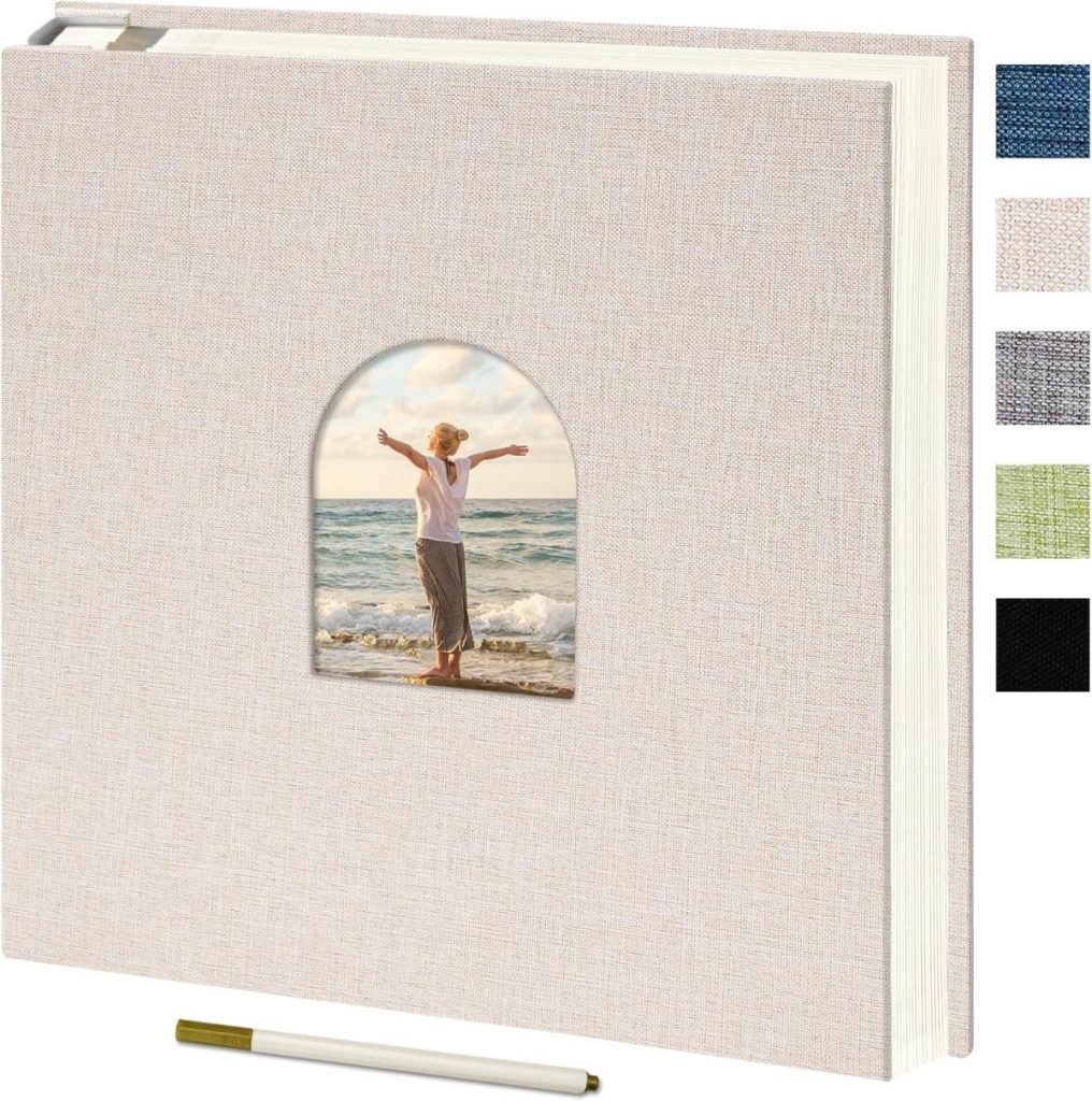 Beige photo album with a window showing a person standing on a beach, displayed alongside a pen, four color swatches, and elegant wax seals for adding a personalized touch.