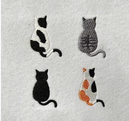 Four embroidered cats, each with different fur patterns, are depicted sitting with their backs turned on a light gray fabric background.