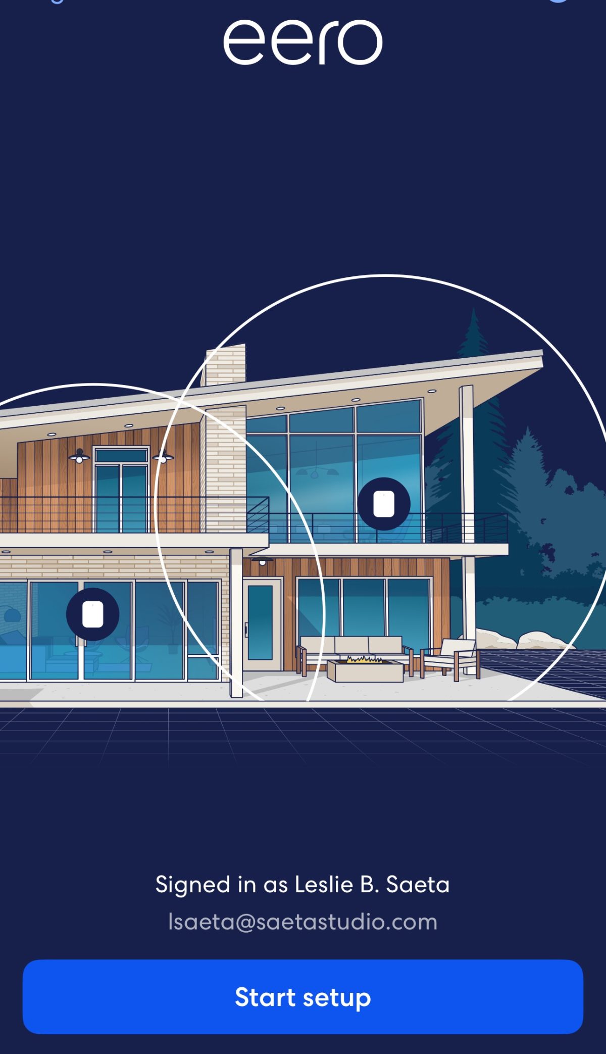 Illustration of a modern two-story house with large windows, overlaid with circular patterns; text indicates user Leslie B. Saeta is signed in. “Start setup” button is visible at the bottom.