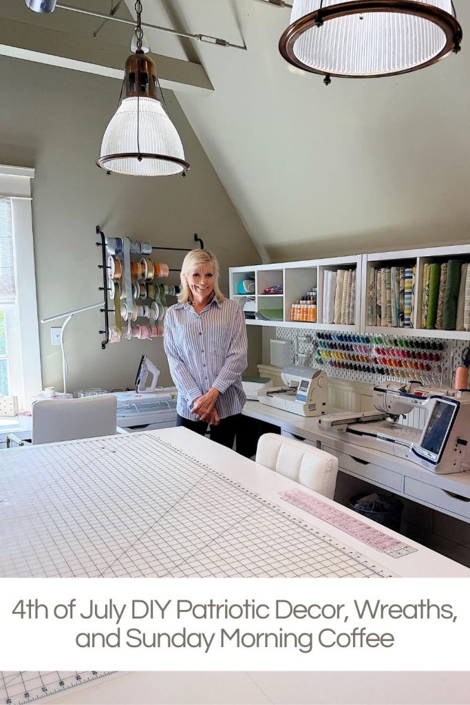 A woman stands in a well-organized craft room with fabric, threads, and sewing machines. A large table is in the foreground. Text at bottom reads, "4th of July DIY Patriotic Decor, Wreaths, and Sunday Morning Coffee.