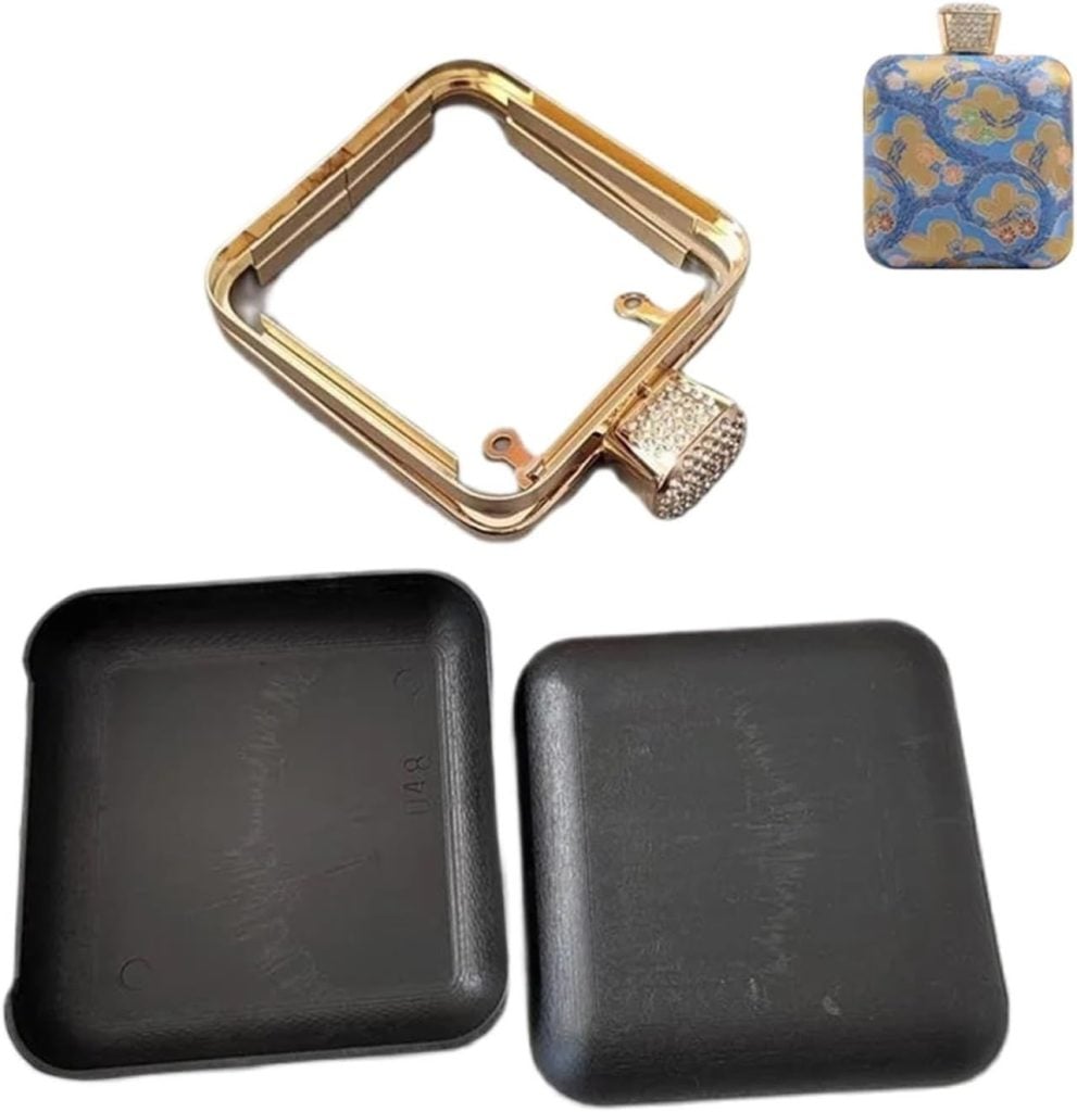 Gold square watch frame with gem-accented crown, two black case covers, and a small floral-patterned case in the top right corner.