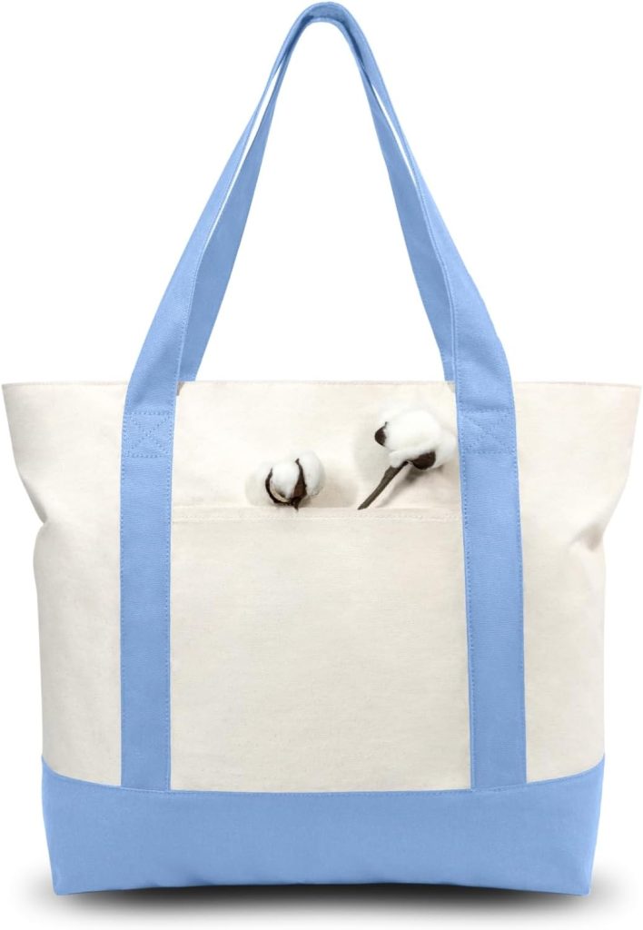 A canvas tote bag with light blue straps and base, featuring a front pocket decorated with two cotton boll illustrations, is perfectly sized for carrying your essentials or even a few polymer clay charms.