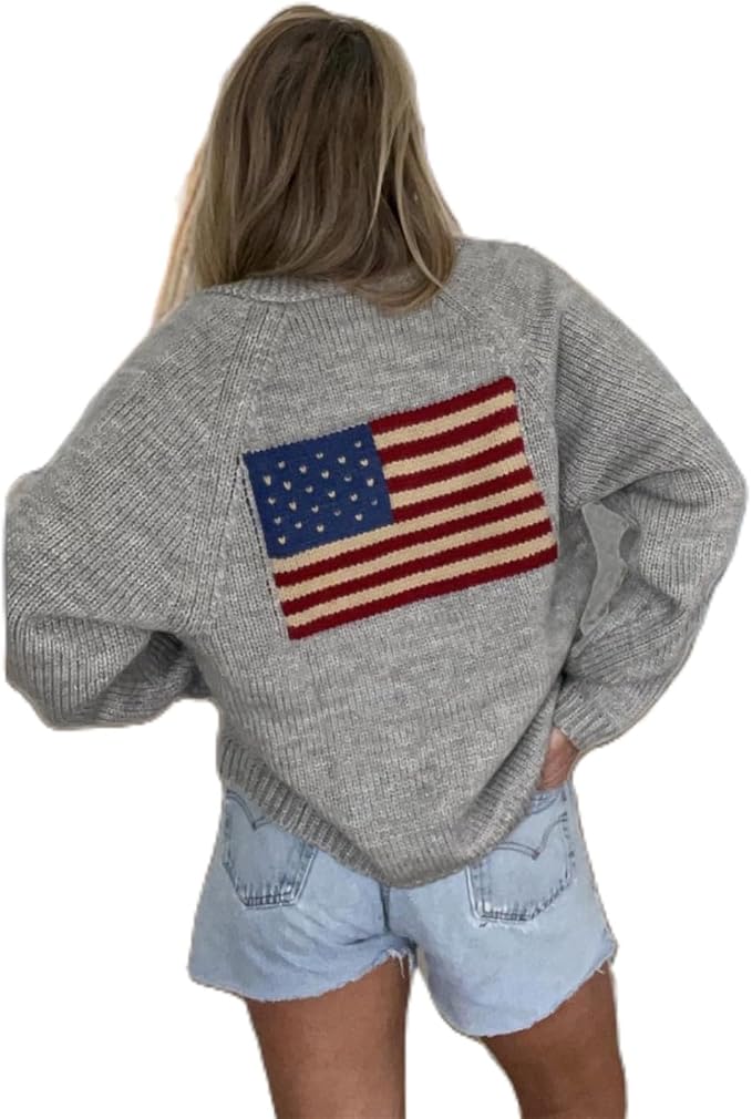 A person wearing a grey sweater with a large American flag design on the back and light blue denim shorts, facing away from the camera.