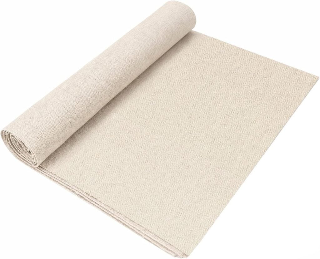 A rolled-up sheet of beige fabric, partially unrolled on a flat surface.