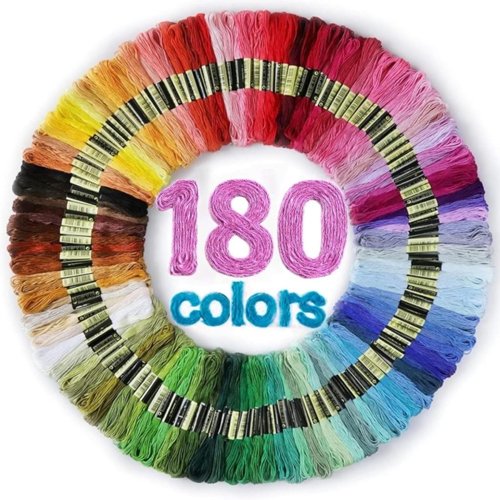 A circular arrangement of embroidery floss in 180 different colors inspires creative ideas, with "180 colors" written in pink and blue thread at the center.