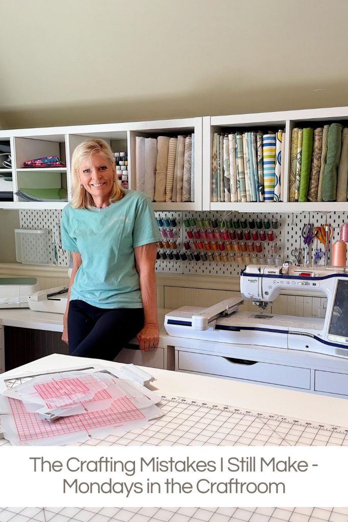 A woman stands in a craft room with shelves of fabric, thread, and a sewing machine; cutting mats and patterns are visible on a table.