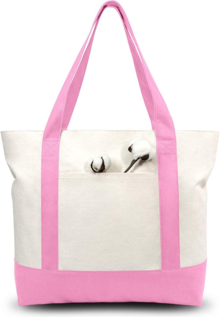 White canvas tote bag with pink straps and bottom, featuring a small pocket on the front containing two cotton stems. Accentuate its playful charm by adding beaded bag charms for a personalized touch.