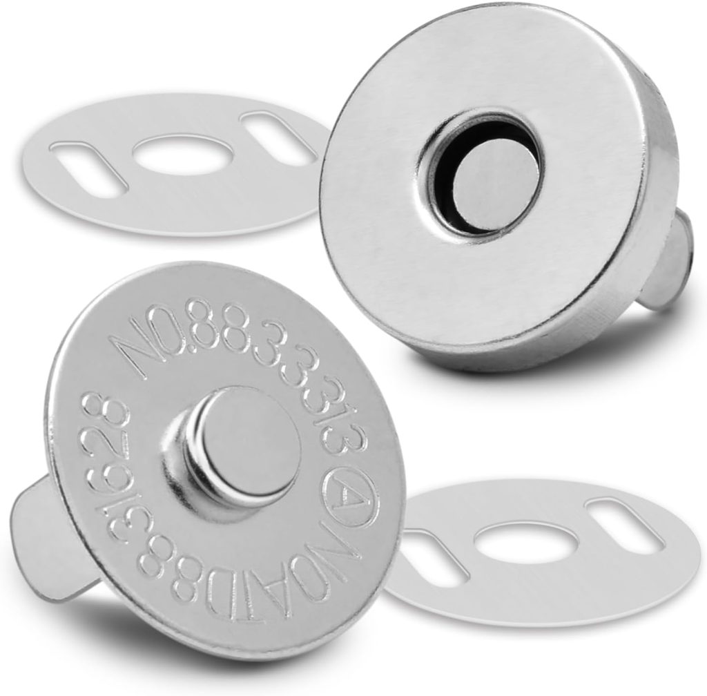 Two silver magnetic snap buttons with corresponding metal back plates, commonly used for fastening bags or wallets, are shown on a white background.