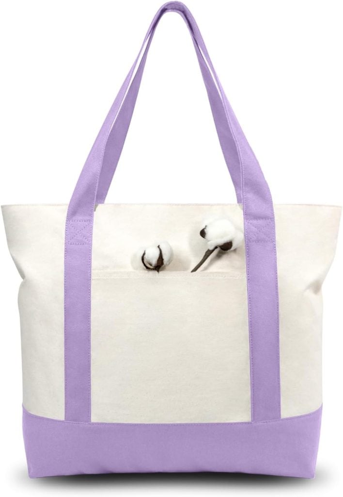 A cream canvas tote bag with lavender handles and trim, featuring two cotton bolls in the front pocket.
